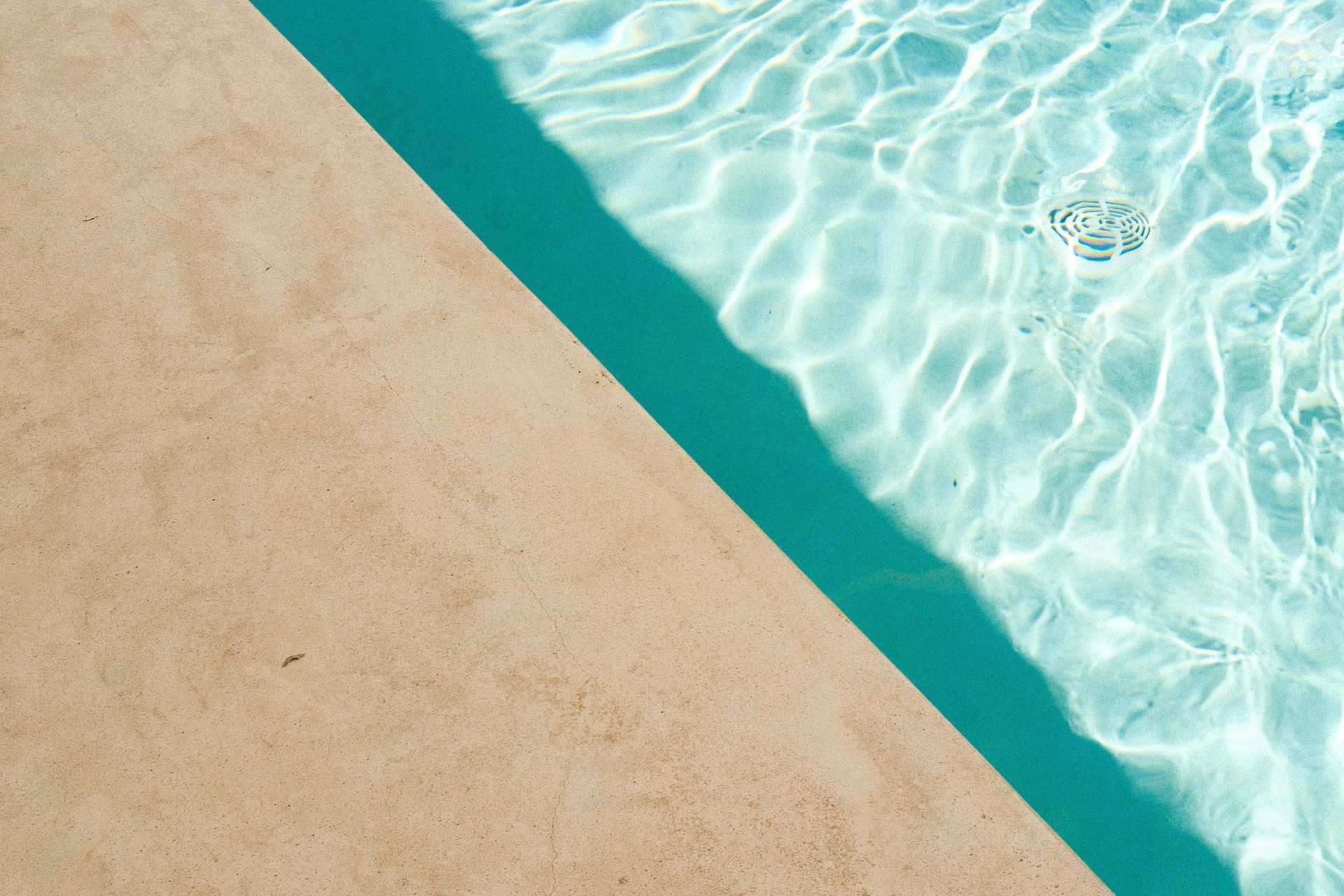 A living room with a concrete floor and a fireplace.