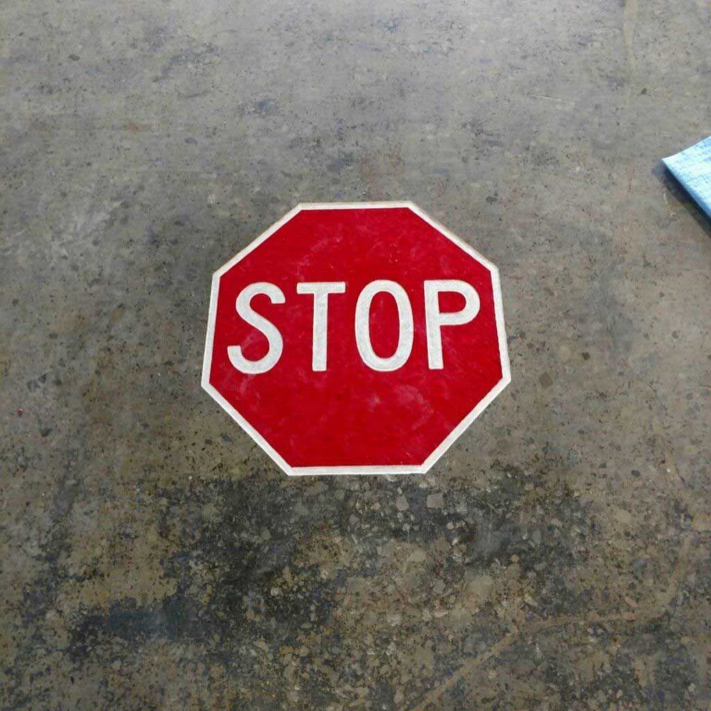 A stop sign is engraved on a concrete surface