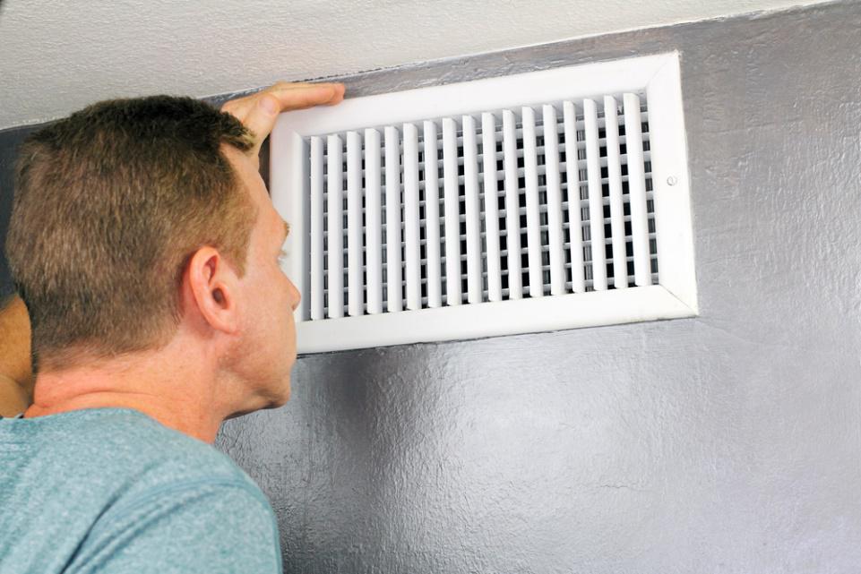 HVAC System Services — Man Inspecting HVAC System in Salt Lake City, UT