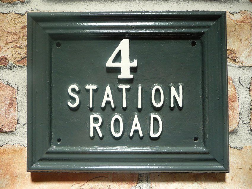 dark green house sign