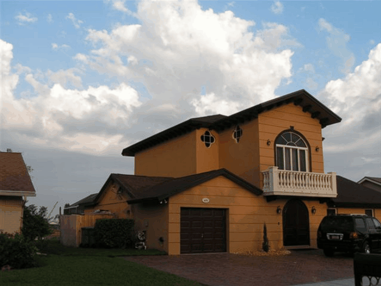 A large house with a car parked in front of it
