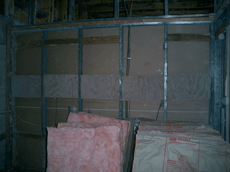 A room with a stack of styrofoam in front of a wall
