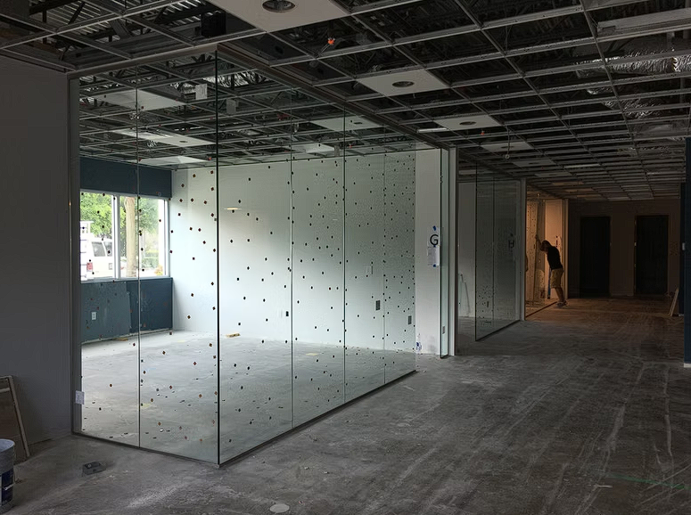 A large empty room with a lot of glass walls