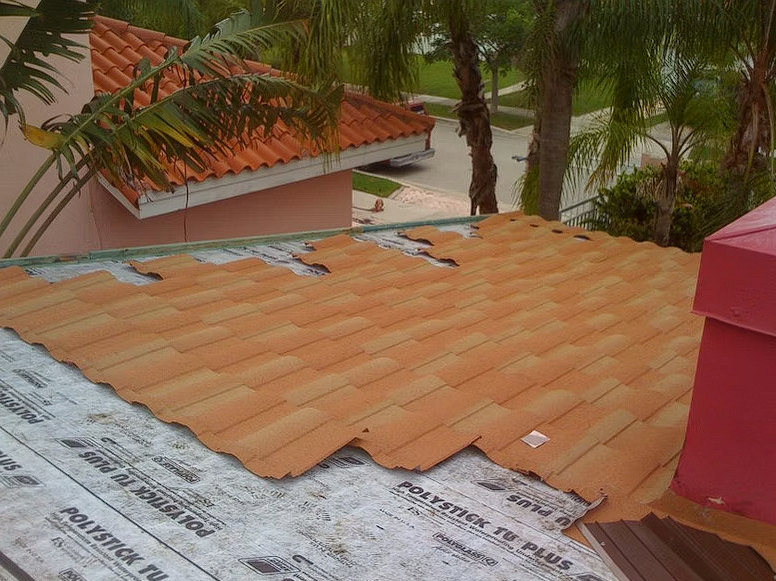 A tiled roof is being installed on a house