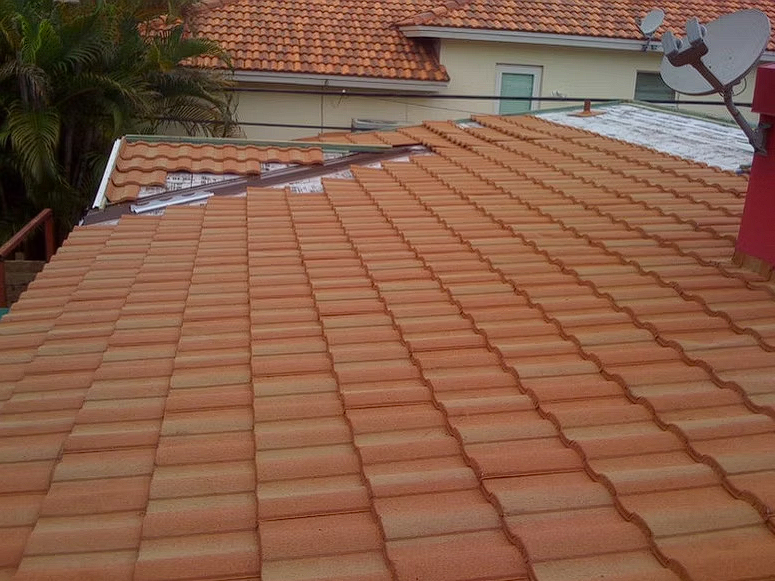 A tiled roof with a satellite dish on top of it.