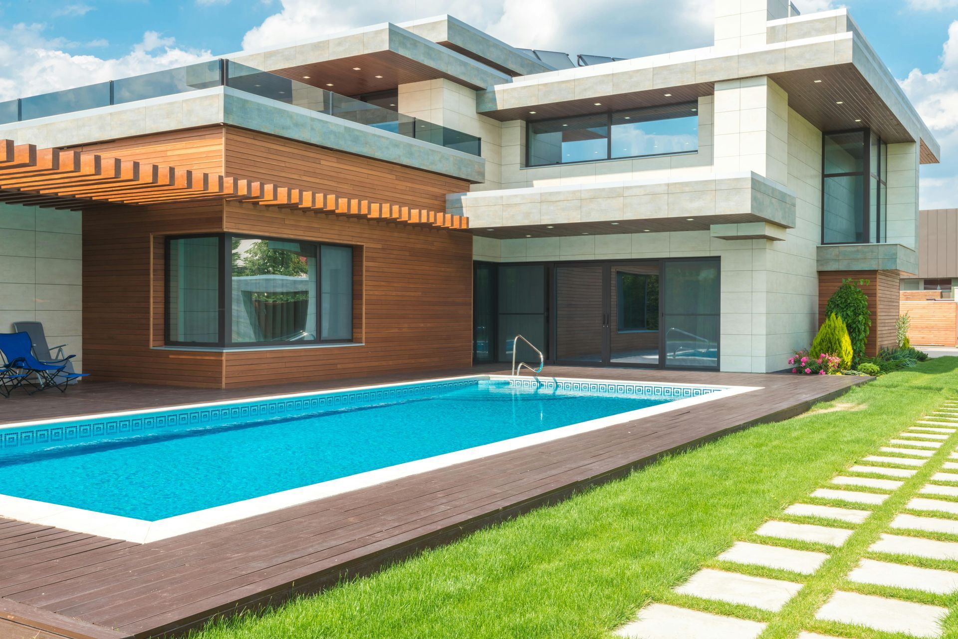 A modern house with a large swimming pool in the backyard.