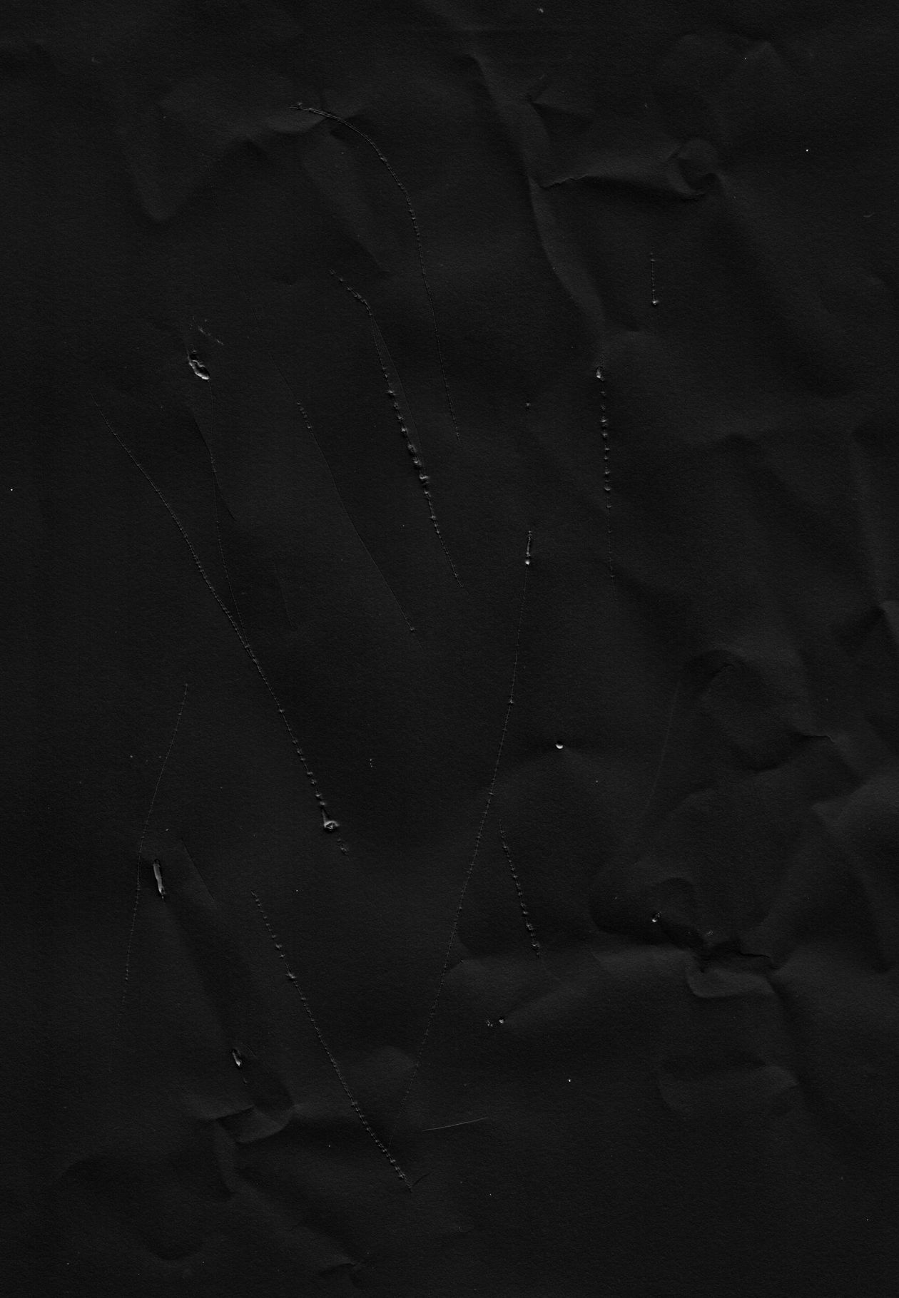 Black, crumpled fabric with diagonal stitching and subtle highlights.