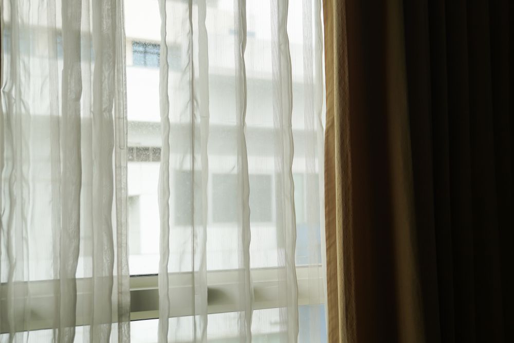 Sheer White Curtains Over a Window — Huntlee Blinds and Shutters in Nowra, NSW