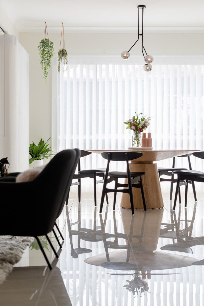 A Dining Room With A Table And Chairs In Front Of A Window — Huntlee Blinds and Shutters in The Illawarra, NSW