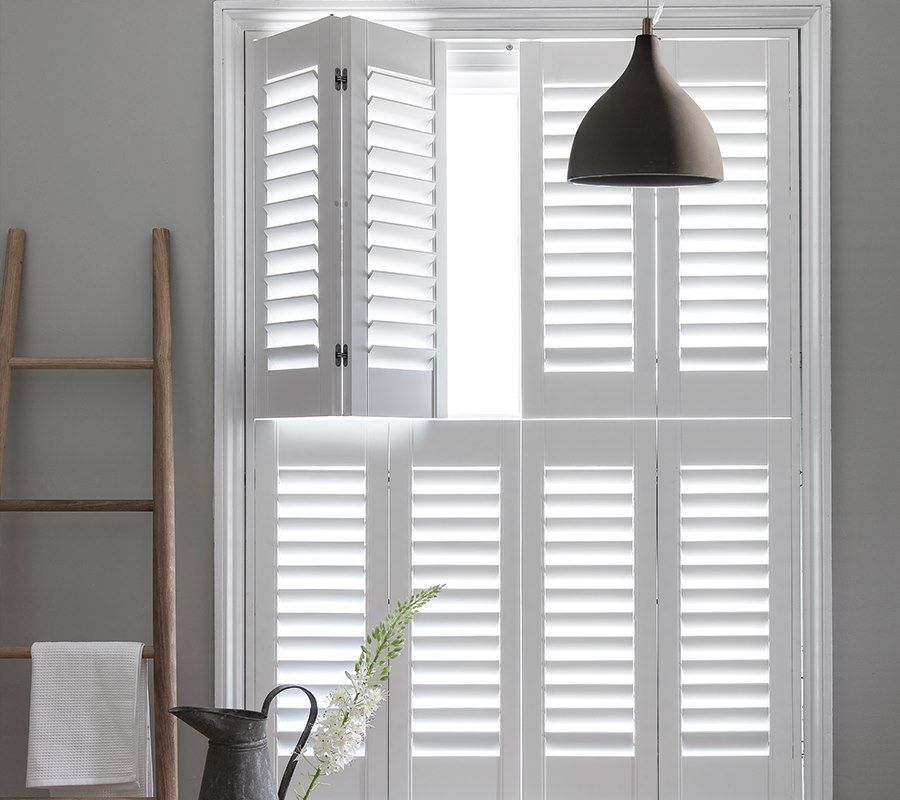 A Close Up Of A White Window With Shutters On It — Huntlee Blinds and Shutters in Badagarang, NSW