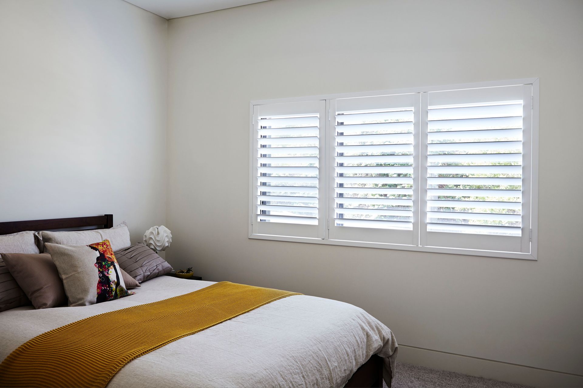 A Close Up Of A White Window With Shutters On It — Huntlee Blinds and Shutters in Badagarang, NSW