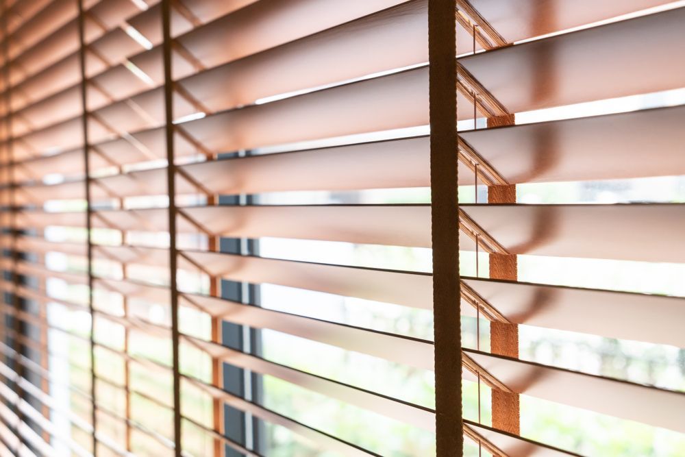 Wooden Window Blinds Partially Open Allowing Soft Light
