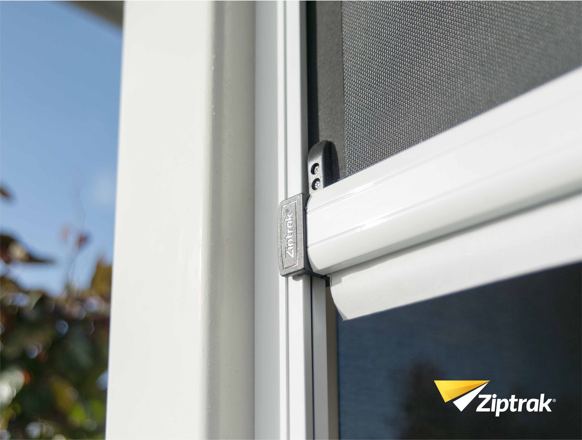 A close up of a window with a Ziptrak logo on it  — Huntlee Blinds and Shutters in Badagarang, NSW
