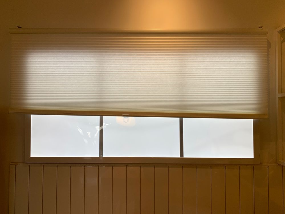 Window With Closed Cream-colored Pleated Blinds — Huntlee Blinds and Shutters in Badagarang, NSW