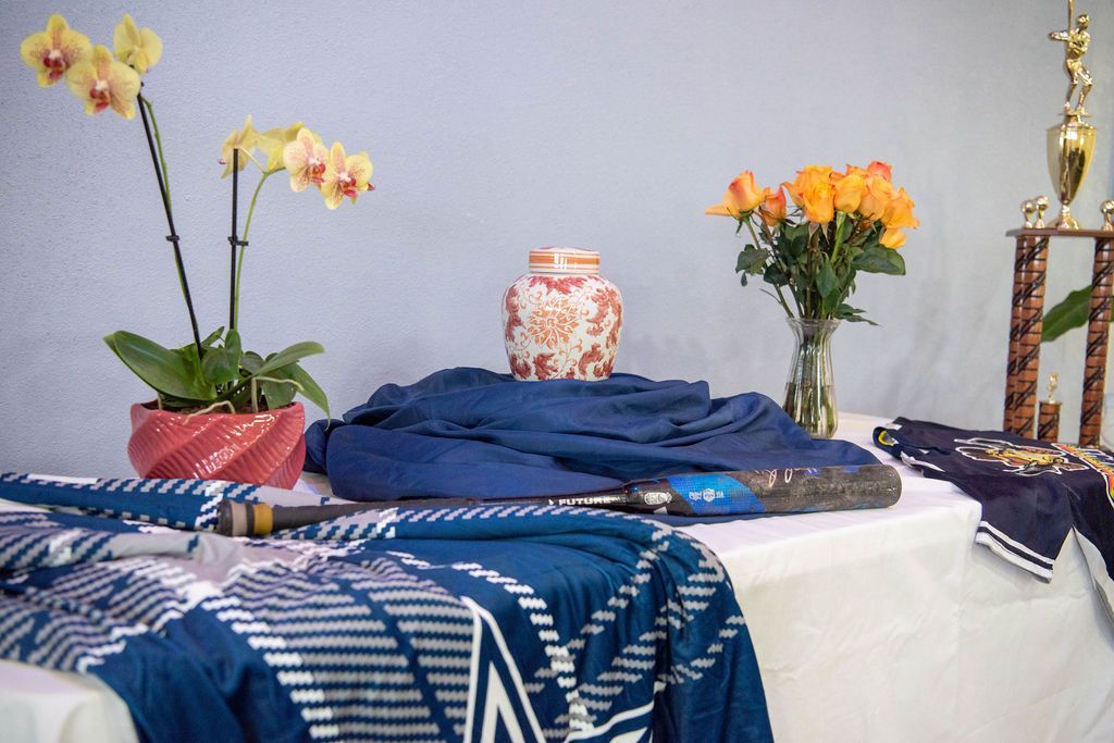 Personalized memorial display featuring keepsakes, flowers, and an urn honoring a loved one's unique life and interests.