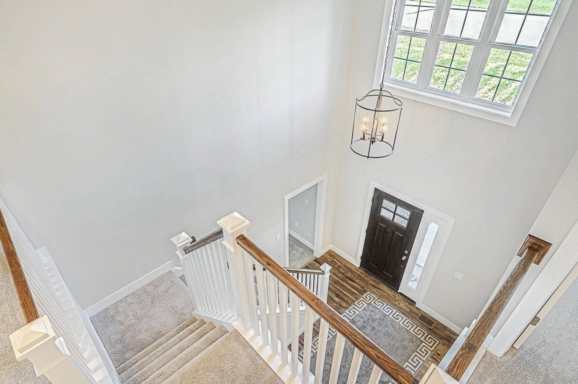 2-story foyer in new home by Landmark Homes with matte black lighting fixture
