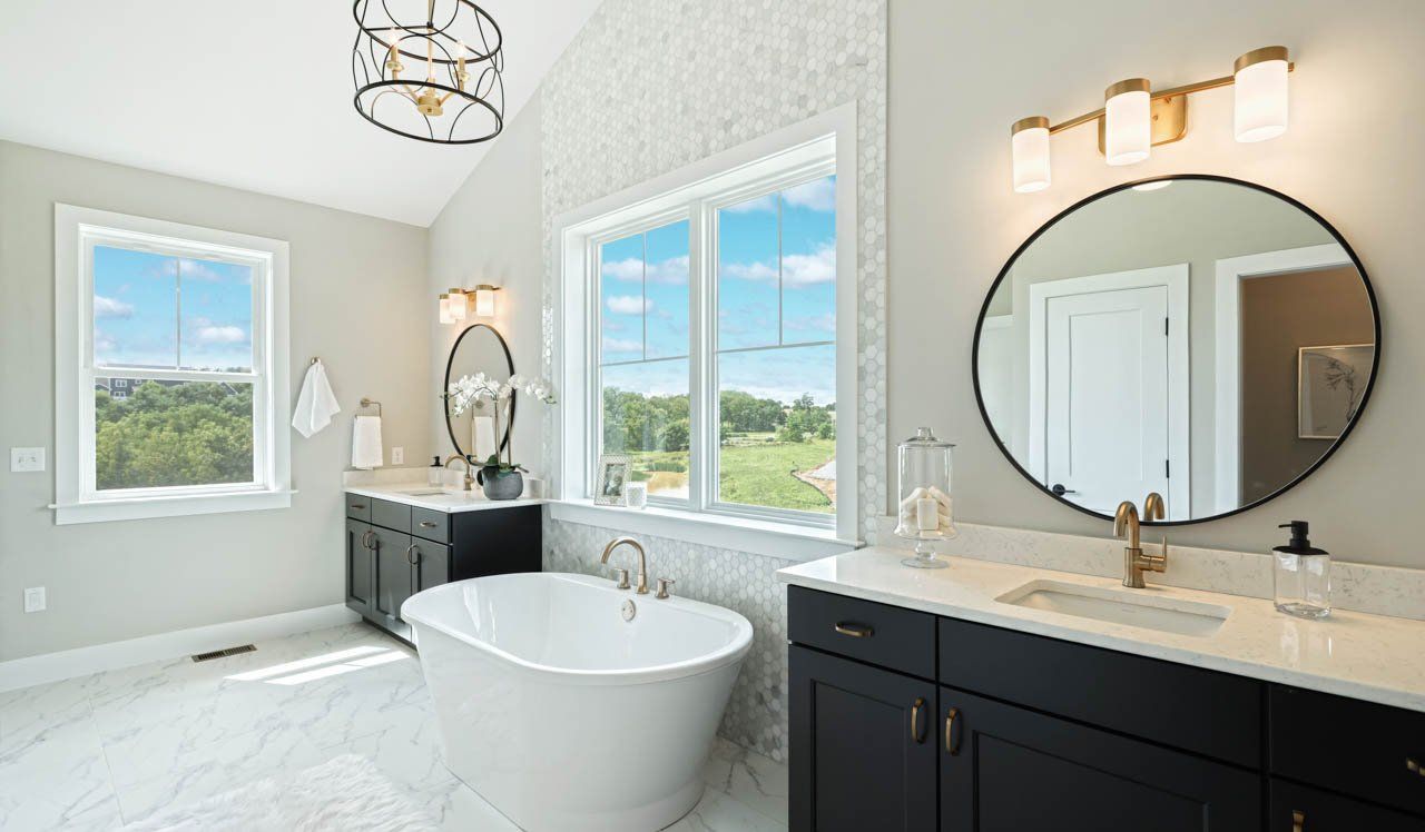 White bathroom in new home with gold and black lighting fixture accents