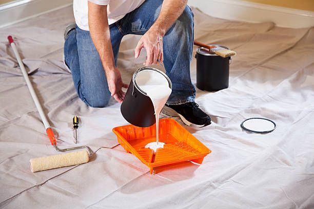Pouring Paint Into Tray — Jacksonville, NC — C & S Paint Center