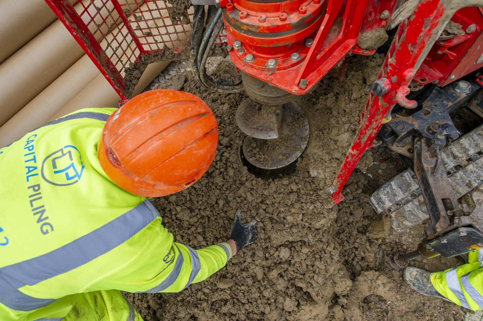 Man operating mini piling machine