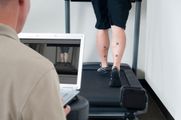 Physical therapy gait analysis on a treadmill with motion markers on the legs