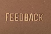 The word “FEEDBACK” in raised tan letters on a brown background.
