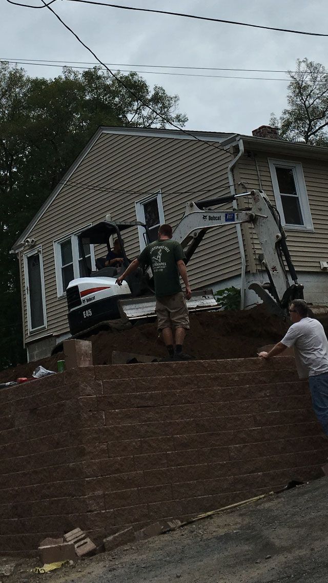 Three Men Working On Landscaping With Bulldozer — Shrewsbury, MA — Maintenance Free Landscapes