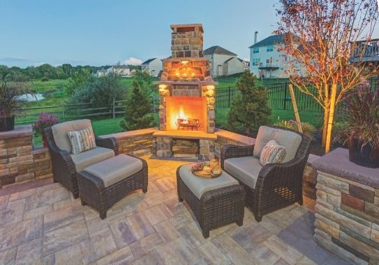 There is a fireplace in the middle of the patio.