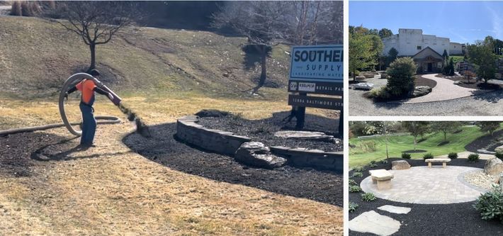 A man is blowing mulch into a garden in front of a building.
