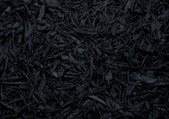 A pile of black mulch is sitting on the ground.