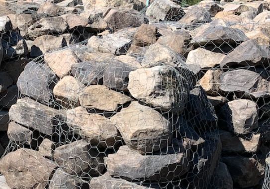A pile of rocks sitting on top of each other in a net.