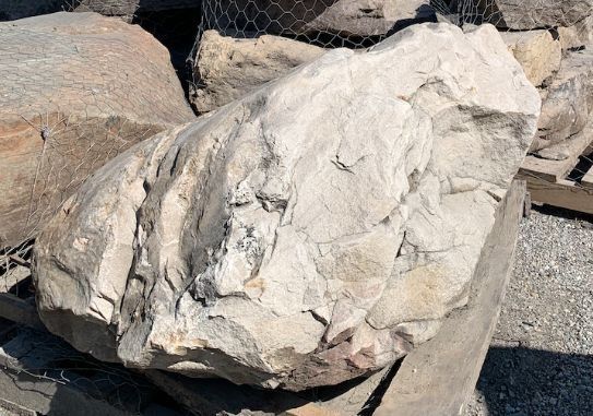 A large rock is sitting on top of a pile of rocks.