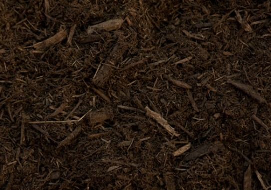 A close up of a pile of brown mulch.