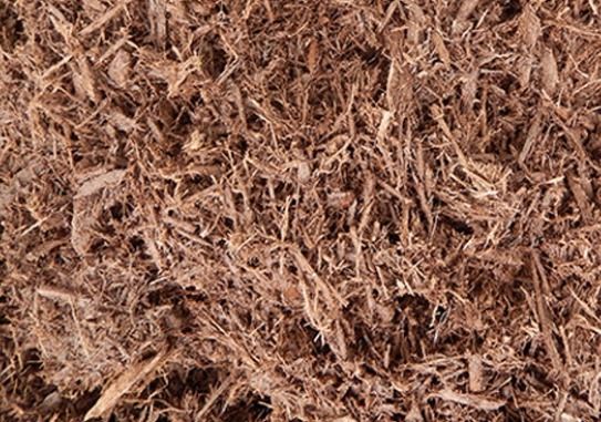 A close up of a pile of brown mulch.