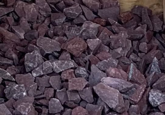 A pile of purple rocks sitting on top of each other on a table.
