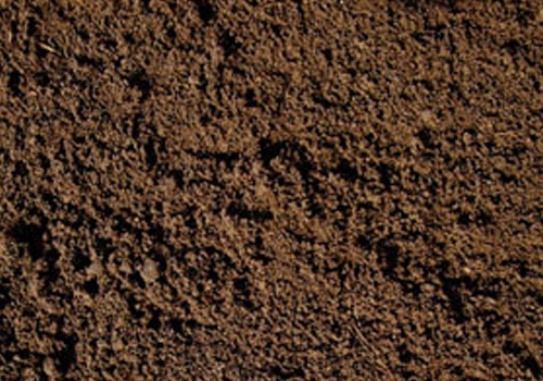 A close up of a pile of brown soil.