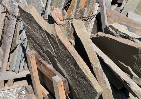 A pile of rocks and wood are stacked on top of each other.