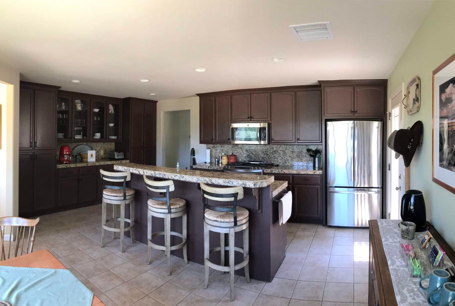 A kitchen with brown cabinets and stainless steel appliances