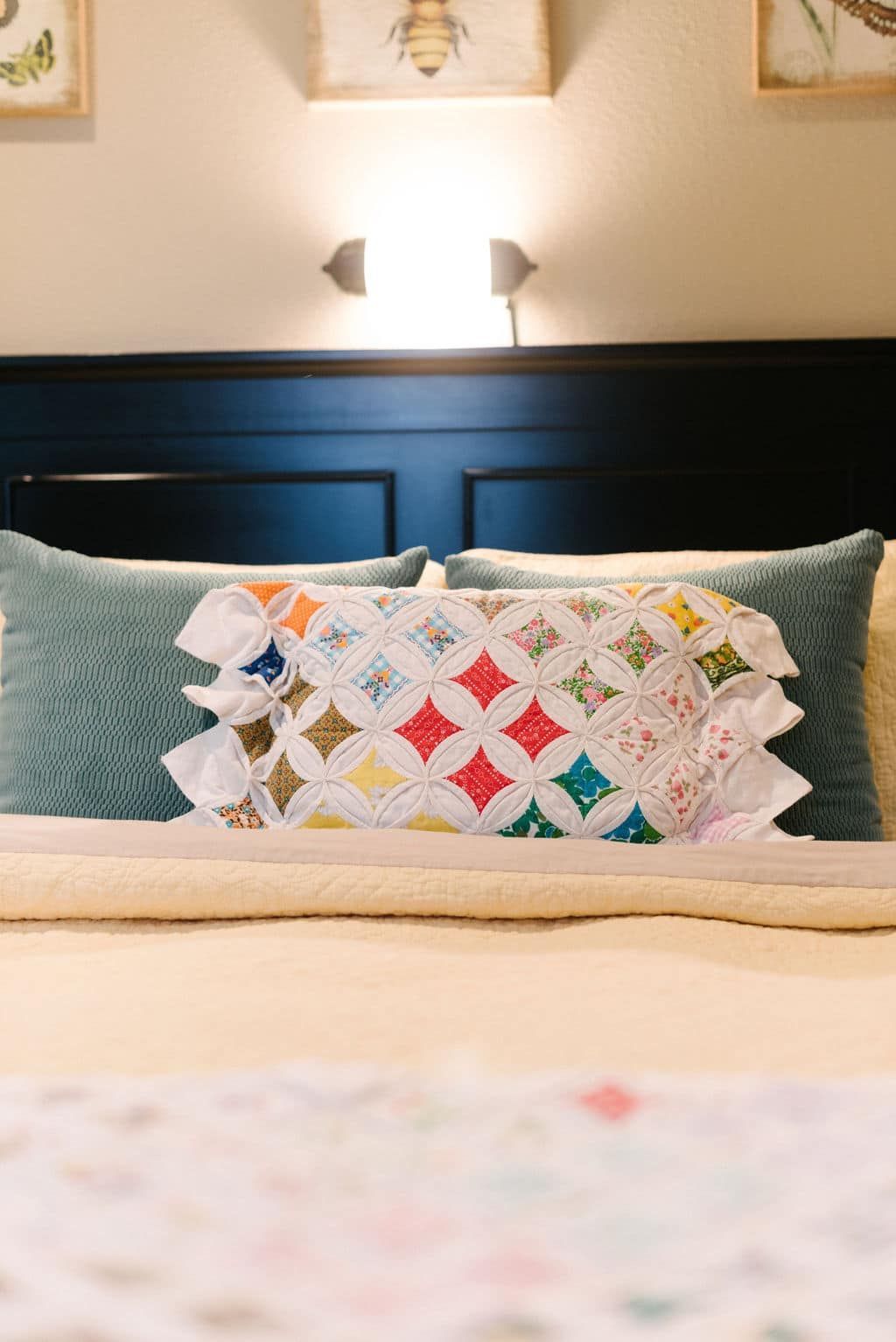 A bed with a quilt and pillows on it.