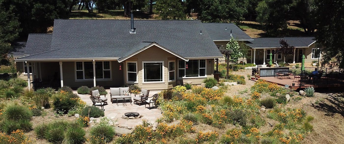 An aerial view of a house in the middle of a field
