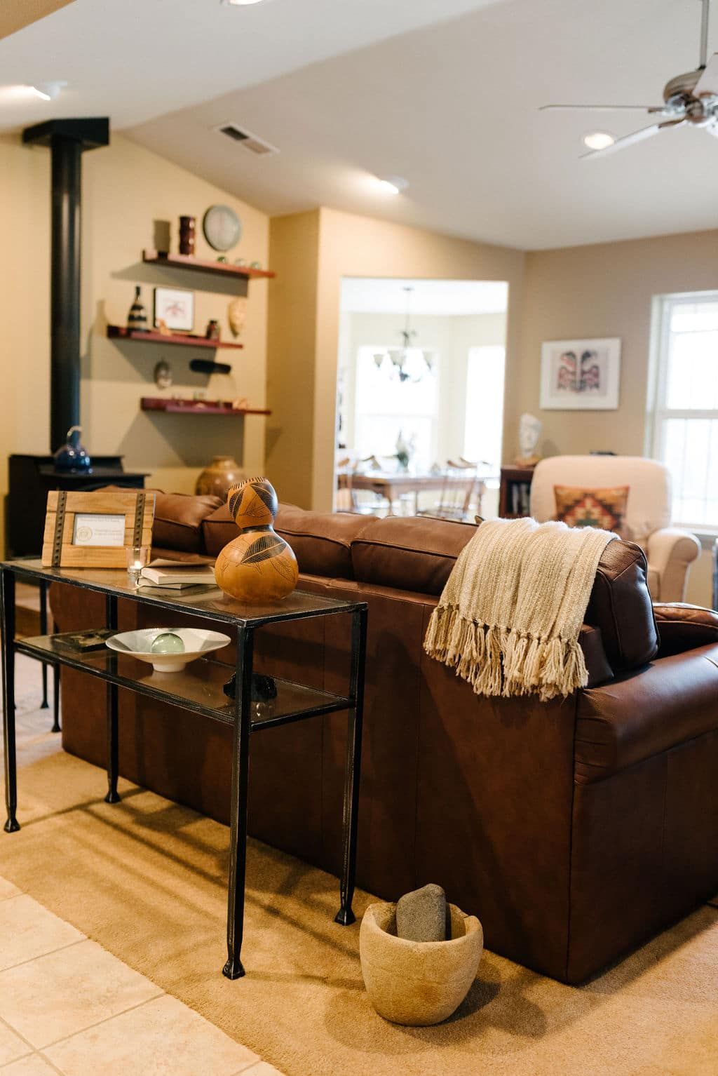 A living room with a brown couch and a table