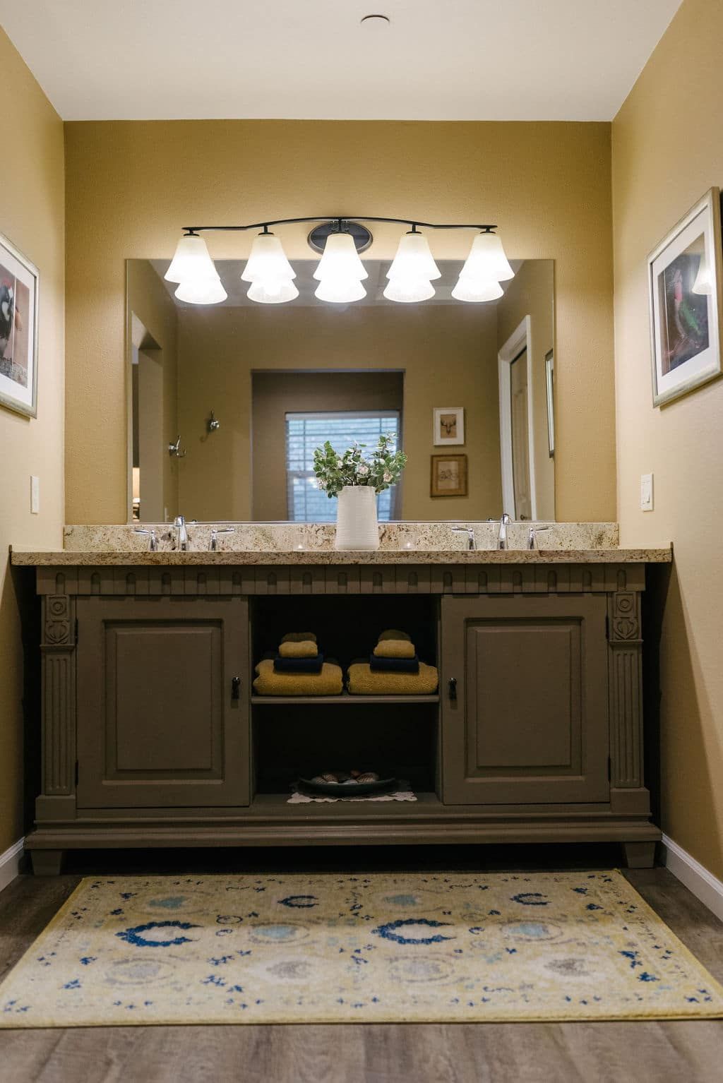 A bathroom with two sinks and a large mirror.