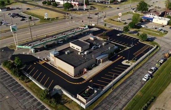Aerial view of a commercial building with newly paved parking.