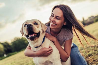 Physicals — Young Healthy Woman with a Dog in Wichita, KS