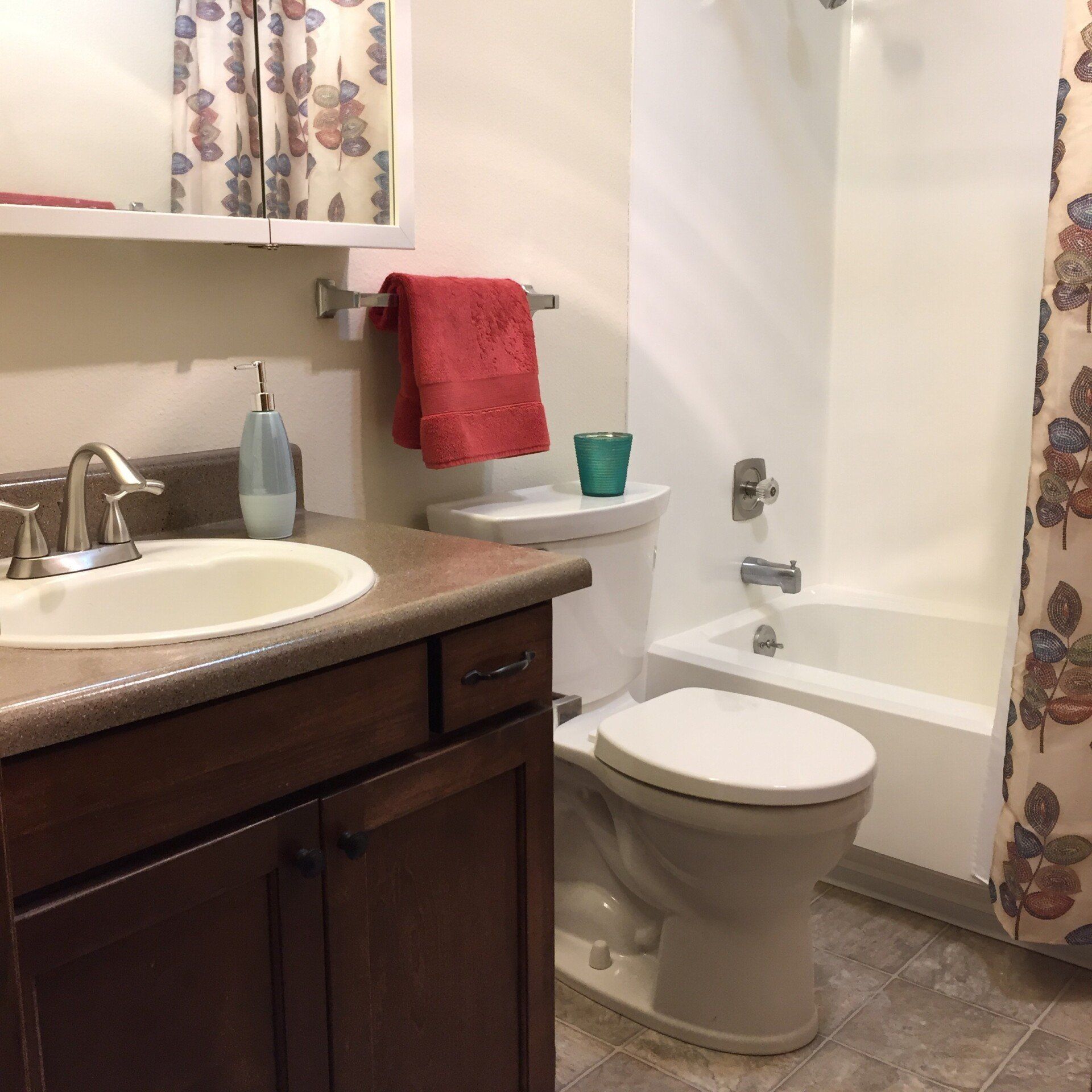 A bathroom with a toilet a sink and a bathtub