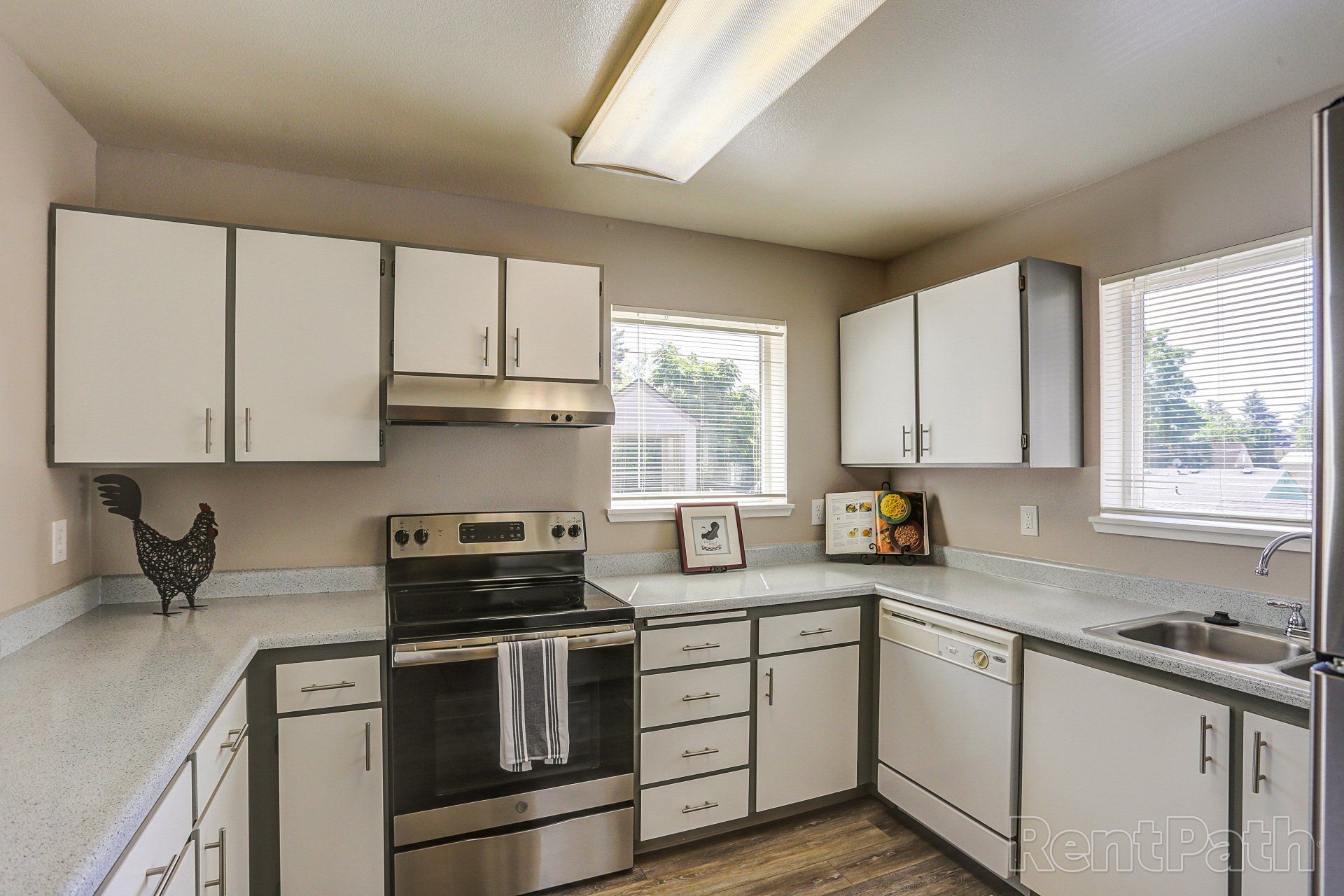 A kitchen with stainless steel appliances and white cabinets