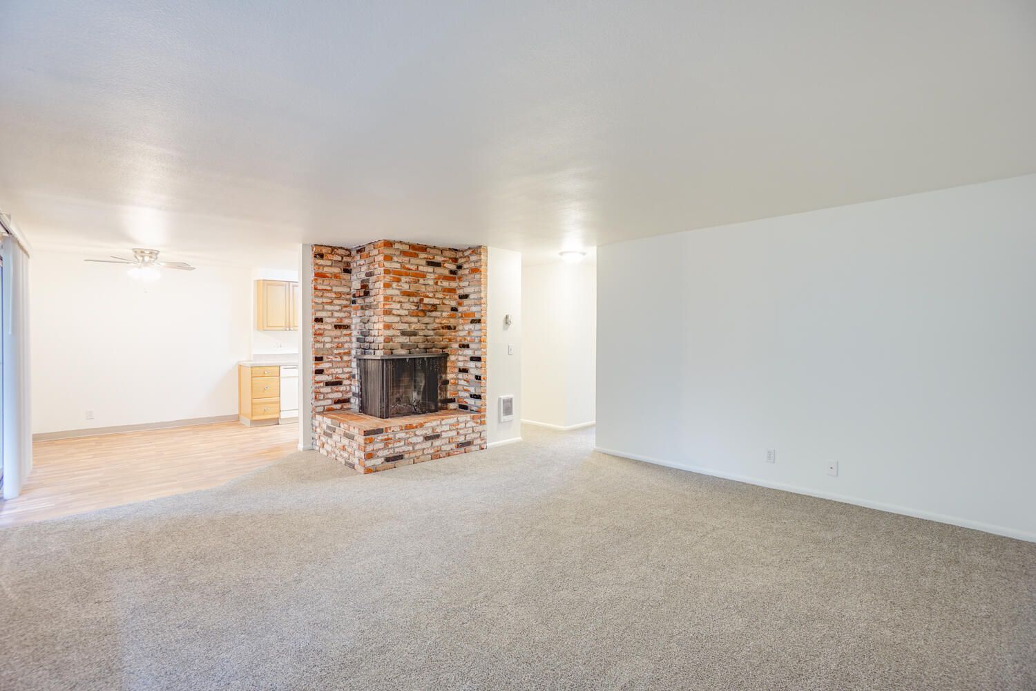 There is a fireplace in the middle of the living room.