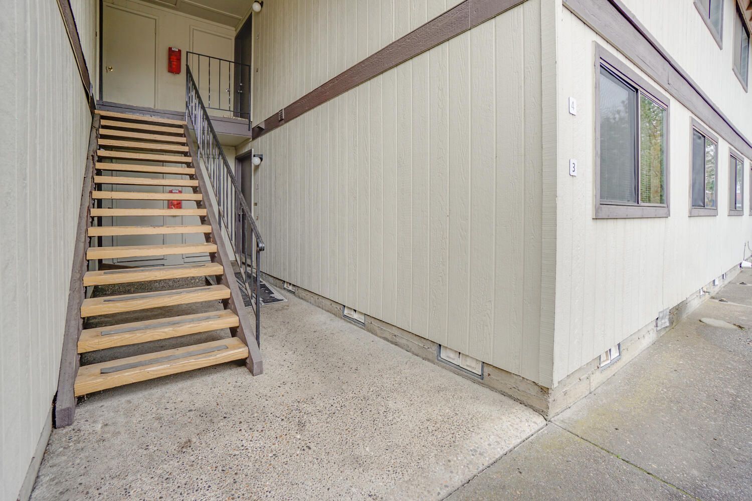 A set of wooden stairs leading up to a building.