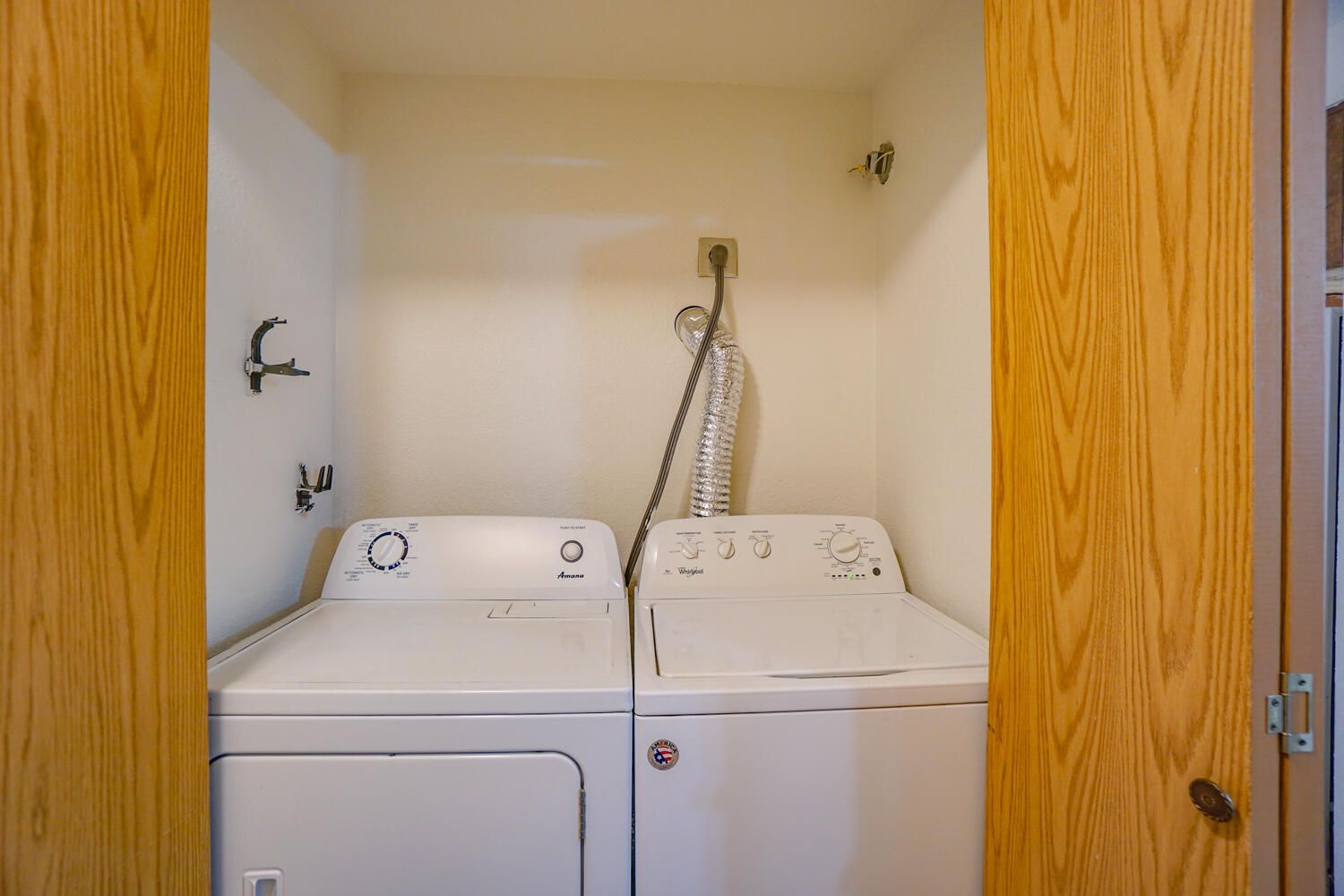 A laundry room with a washer and dryer in a closet.