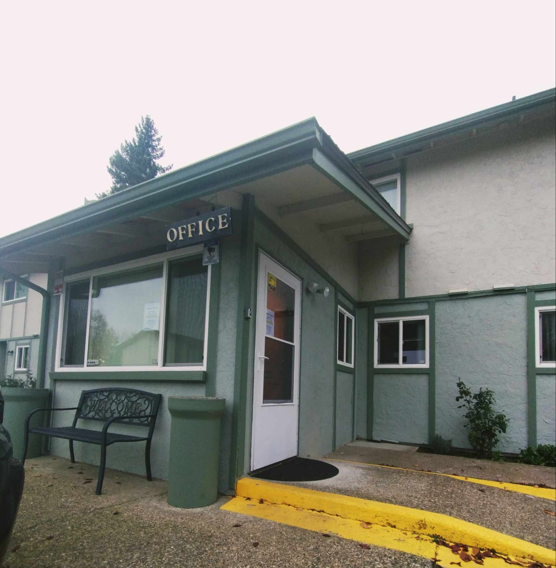 A green building with the word office on it