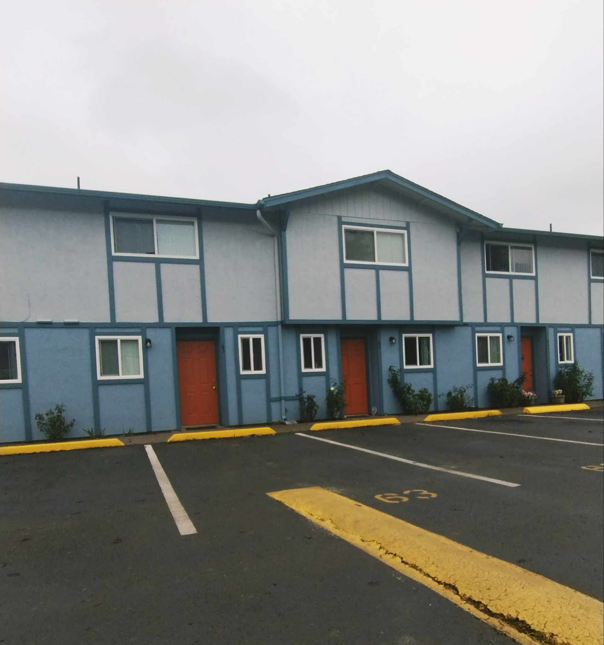 A building with a handicapped parking spot in front of it